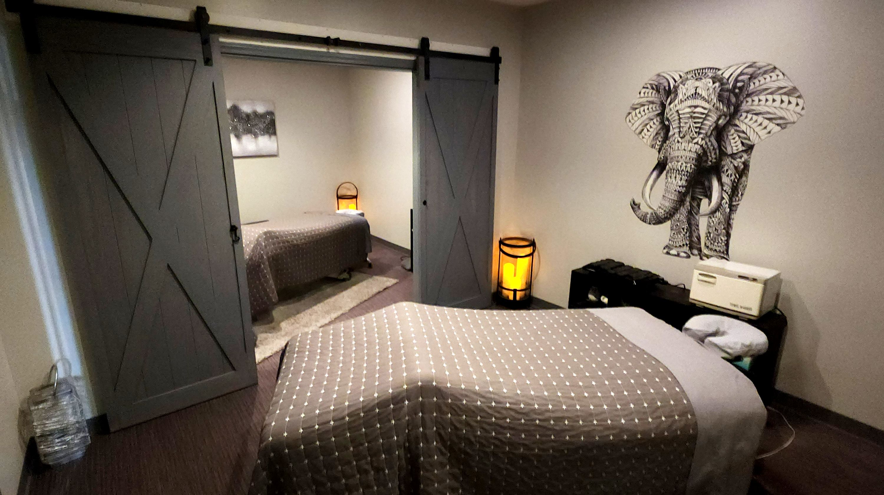 A private massage suite with barn doors and warm lamplight at Majestic Spa & Salon